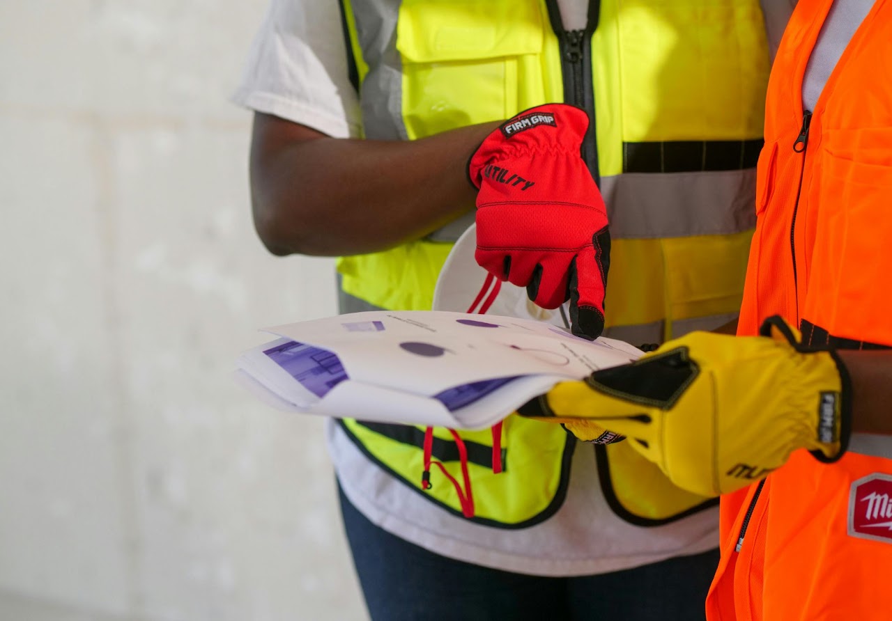 People in safety vests reviewing technical information